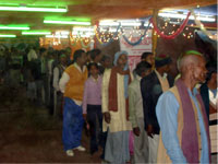 Inside gathering of pilgrims in exhibition Makar Sankranti